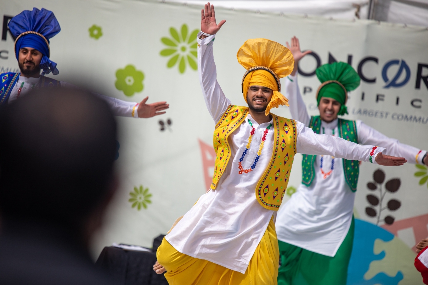 Bangra dancers in bright costumes perform on stage